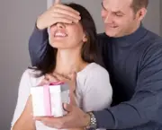 couple in love celebrating, man is giving a gift to his girlfriend