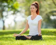 Yoga outdoor. Happy woman doing yoga exercises, meditate in the park. Yoga meditation in nature. Con